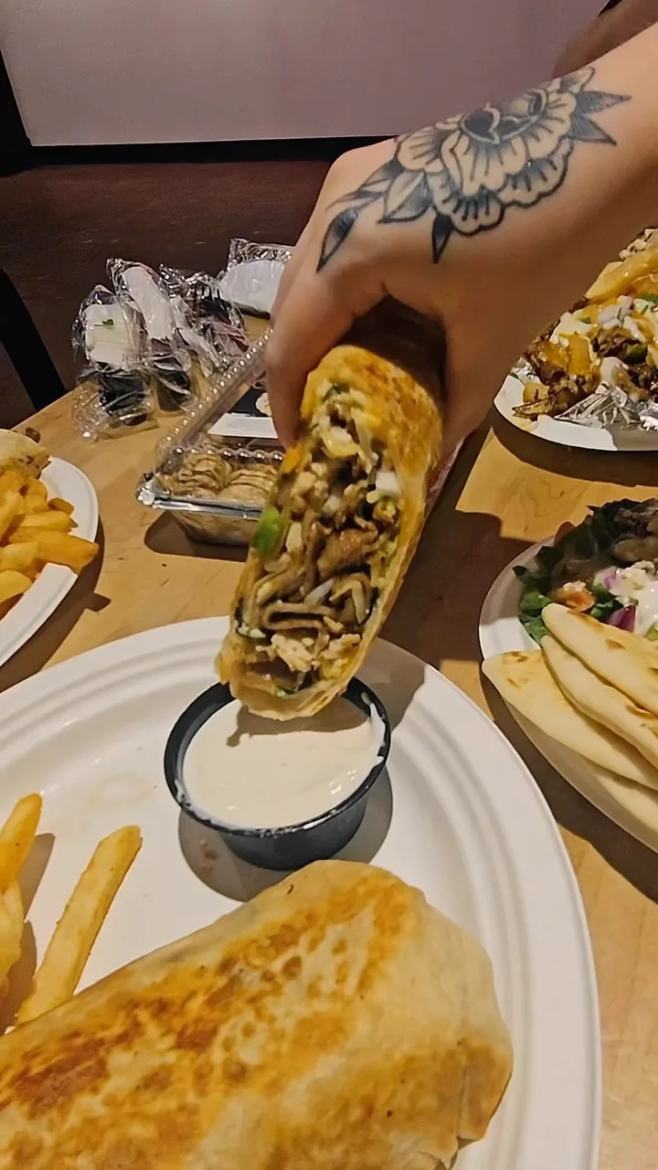 Gyro being plated at a table